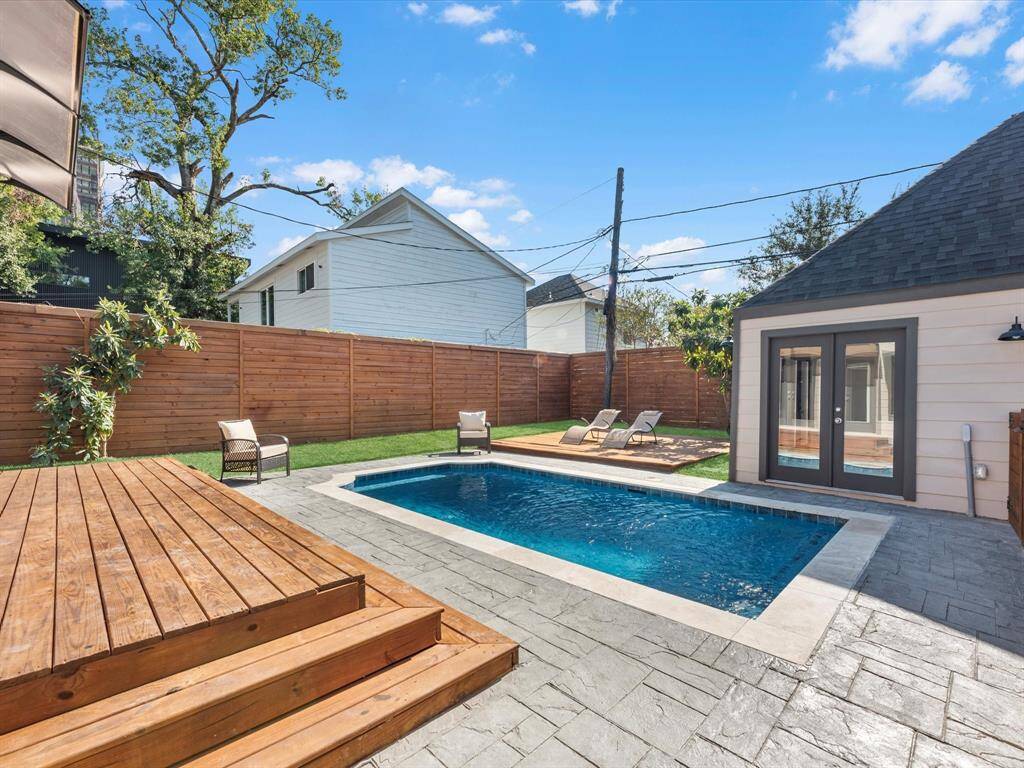 The backyard is enclosed by a 10-foot stained and sealed wooden fence, providing enhanced privacy, durability, and a polished aesthetic.