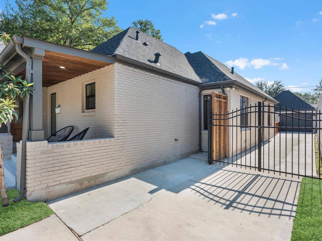 Featuring all-new energy-efficient windows, a durable black asphalt roof, and a stylish wrought iron driveway gate for added security and curb appeal.