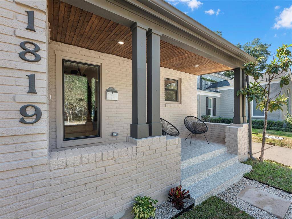 Showcasing a new rich wood ceiling, modern lighting, and sleek upgraded pillars for a refined and inviting entryway.