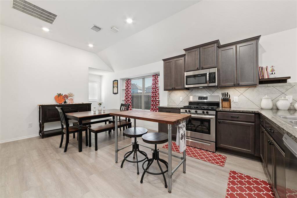 Nice area for a dining table and buffet off kitchen