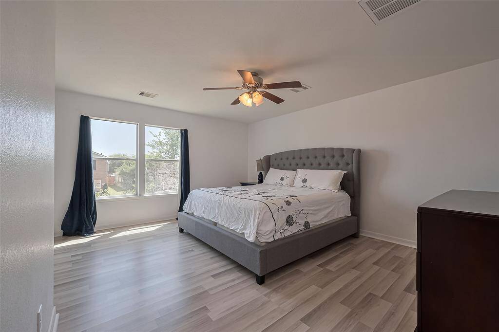 Primary bedroom with large windows