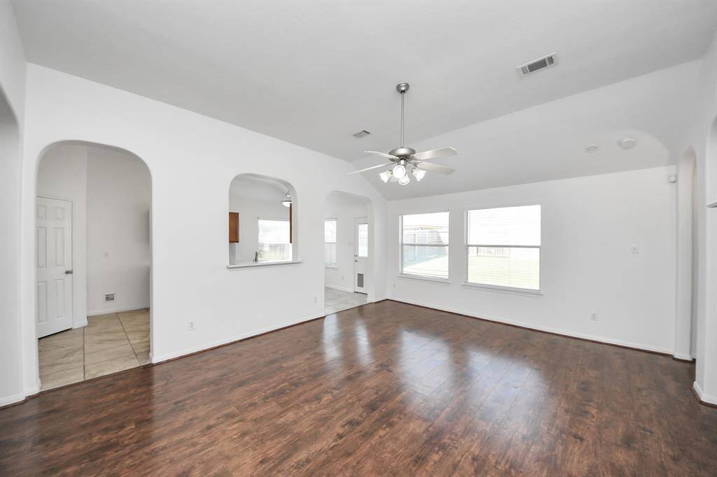 Expansive living room flows seamlessly into the kitchen and dining area, ideal for gatherings.