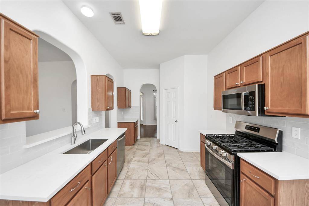 Stylish kitchen boasts stainless steel appliances-NEWER gas range and MICROWAVE!