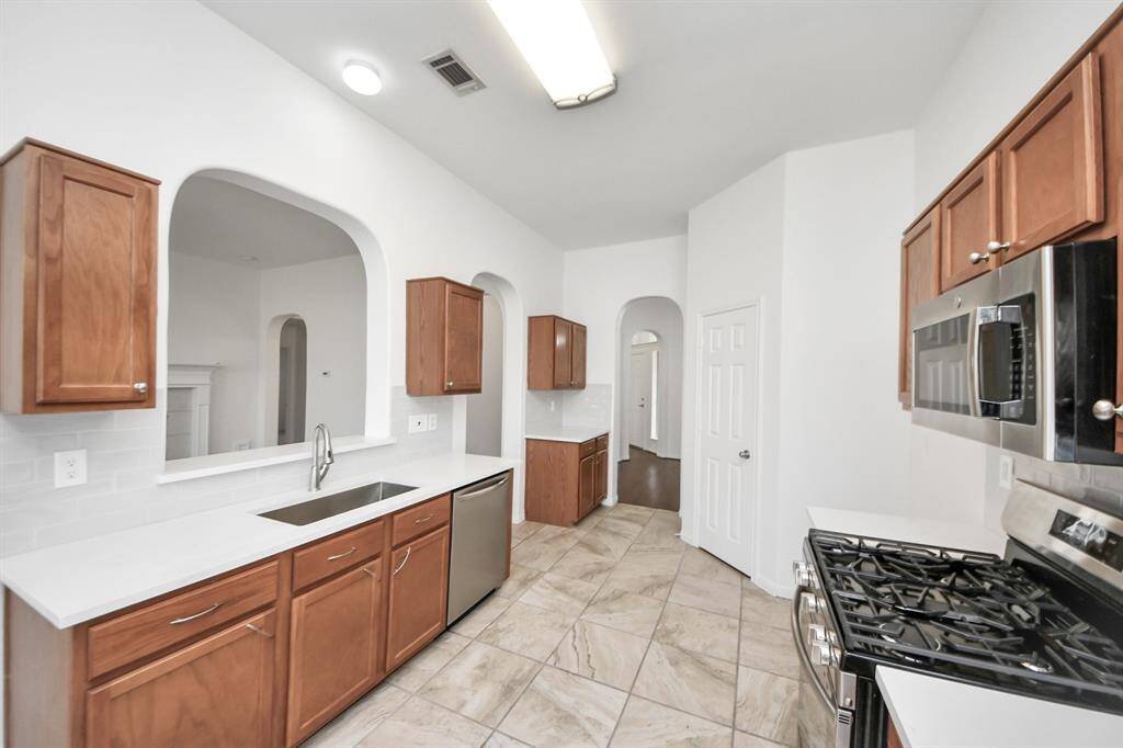 Abundant cabinet space and fresh white quartz counters make this kitchen both beautiful and functional.