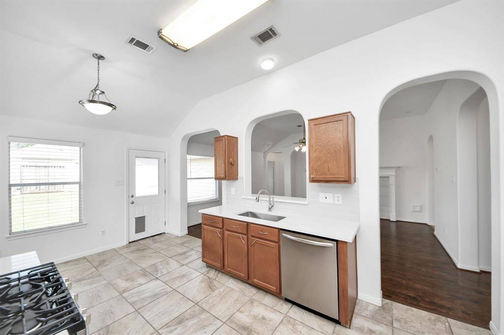 Spacious kitchen with upgraded appliances and tile flooring.