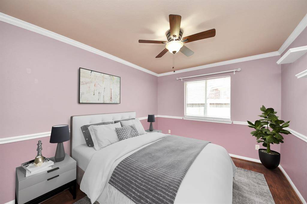 Charming bedroom with crown molding, warm-toned walls, and natural light—perfect for relaxation. (virtually staged)