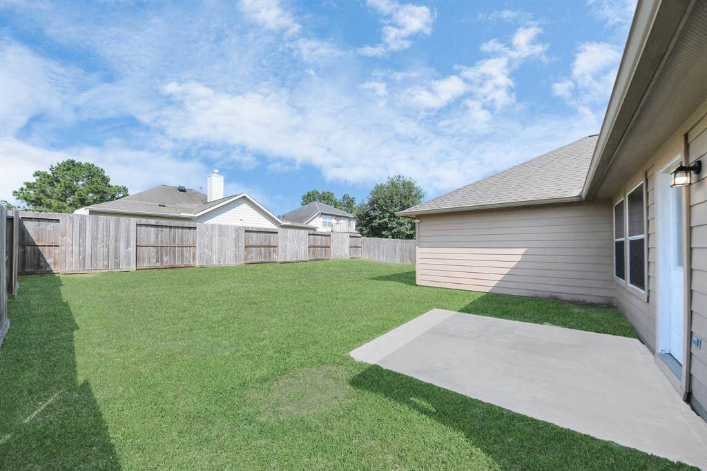 Enjoy a spacious, fully fenced backyard with a concrete patio—perfect for outdoor dining or weekend barbecues.