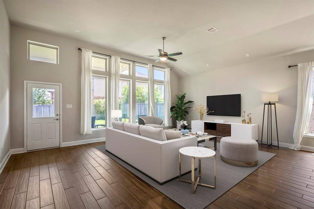 The dining space seamlessly flows in to the living room with ample windows for natural light. (virtually staged living room furniture).