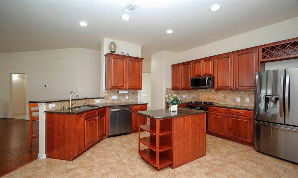 Maple solid wood cabinets, island with display area or cookbooks!