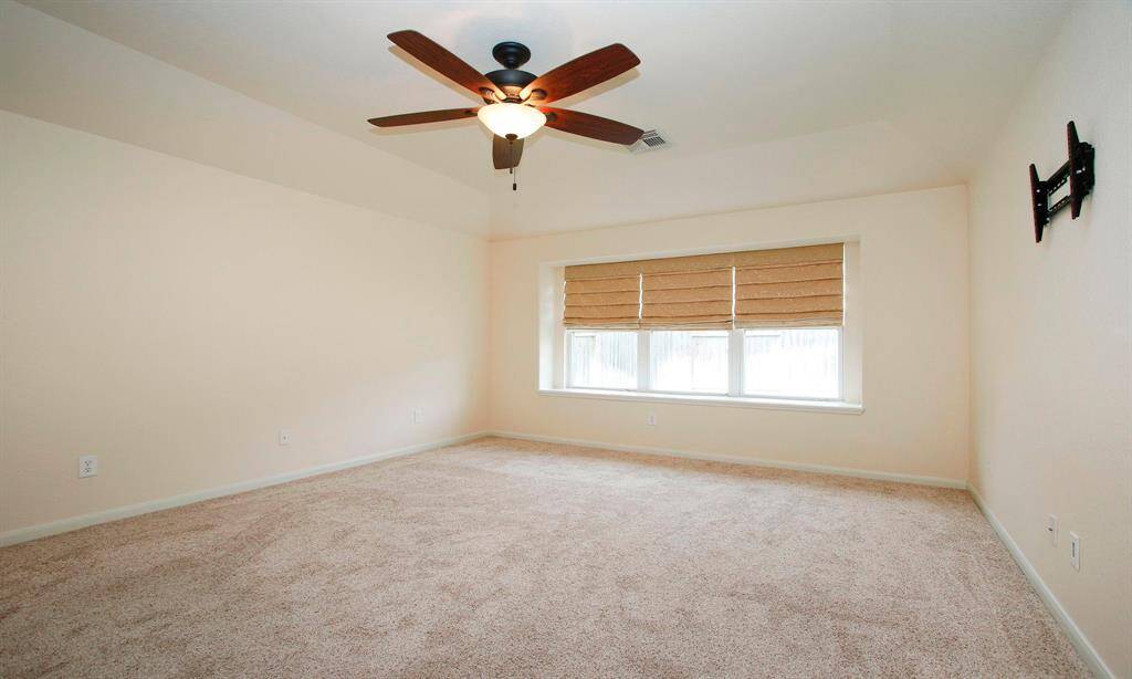 Primary bedroom with triple blinds