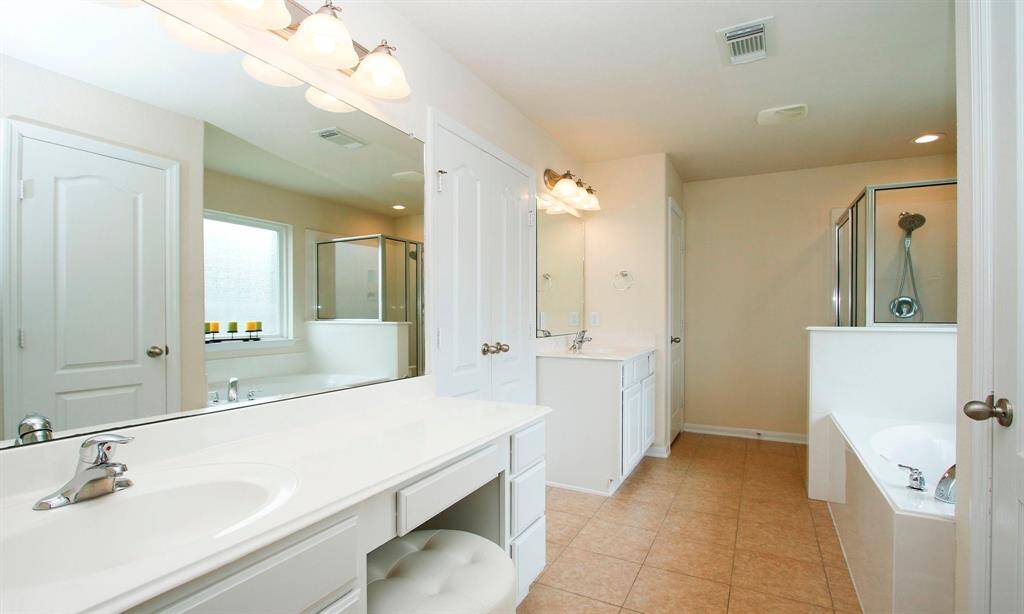 Well planned primary bath with vanity for make up prep and drawer. Double vanity.