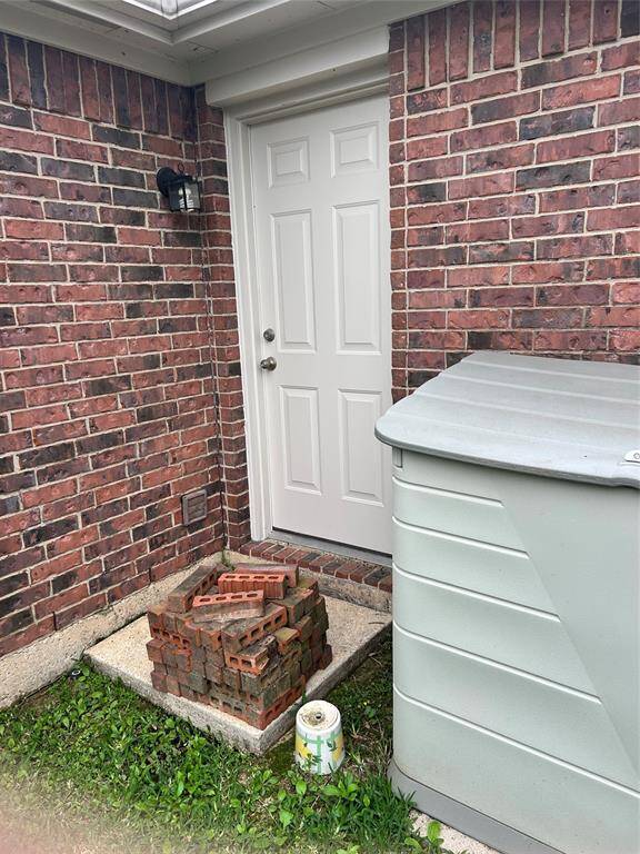 Back door from backyard into the . Extra matching brick.
