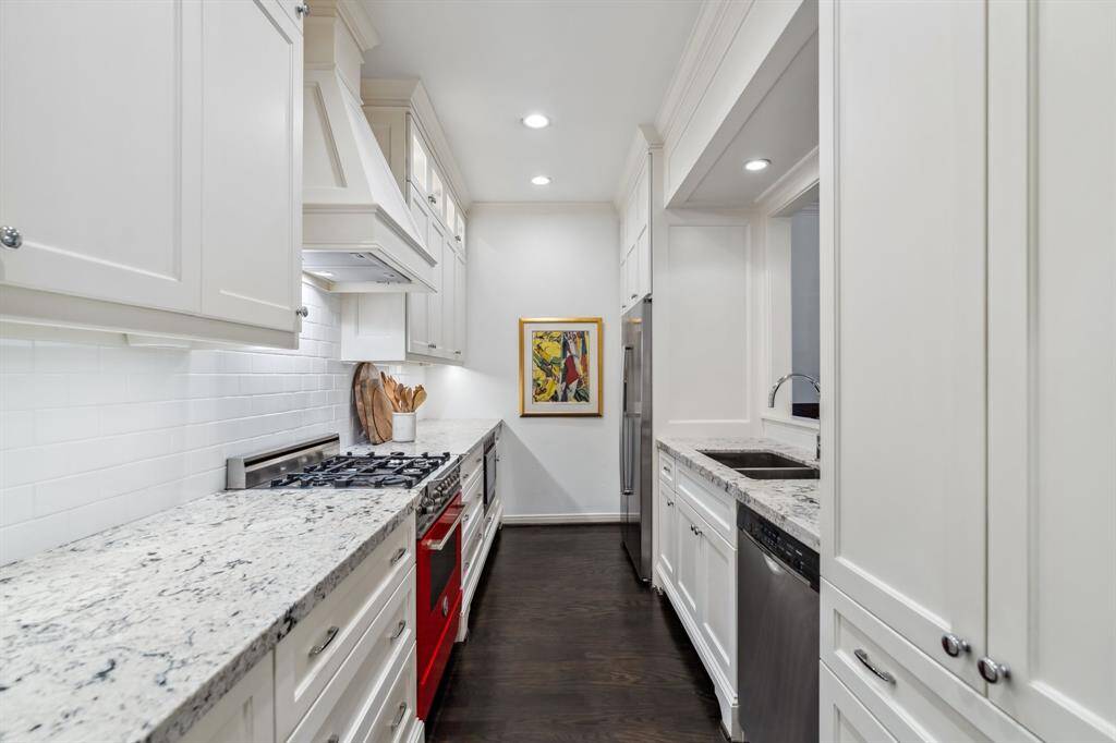 Fully renovated kitchen with custom cabinetry, under-cabinet lighting, and ample recessed lighting throughout.