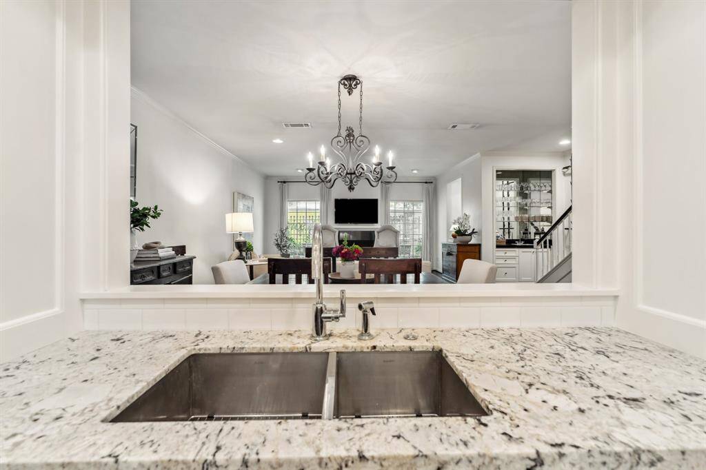 The stainless steel sink sits below a window that looks into the dining room.