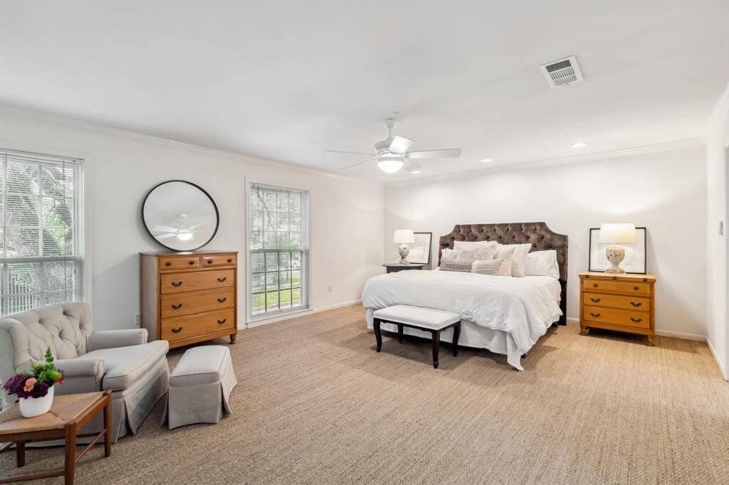 Second upstairs bedroom is equally spacious, with new carpet, neutral walls, and two well-sized windows.