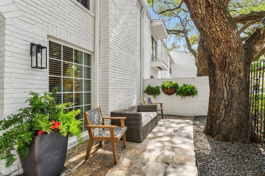 Charming front patio shaded by a mature oak, adding extra room to relax and enjoy.