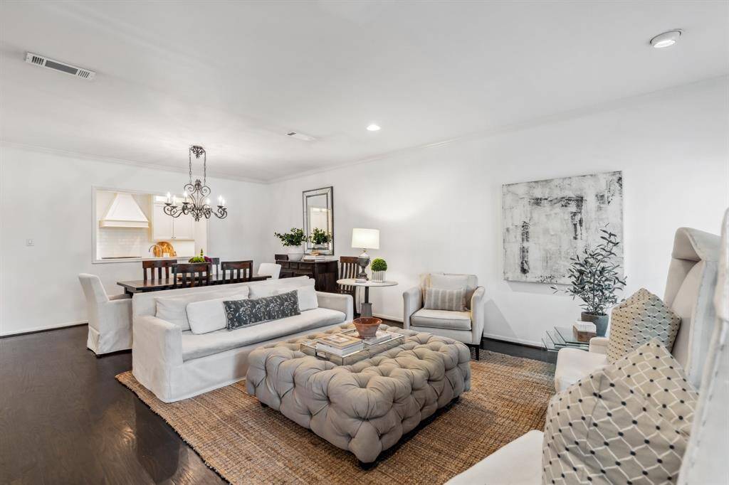 Step through the foyer into a spacious living room that flows seamlessly into the dining area.