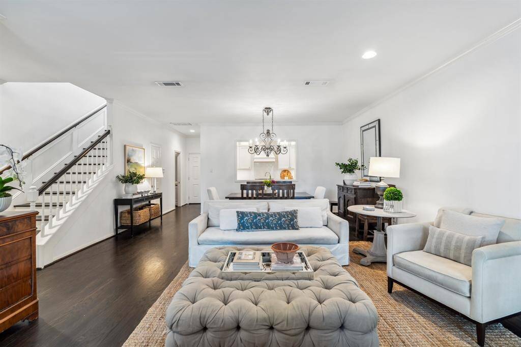 The first floor features hardwood floors, neutral paint tones, and crown molding throughout.