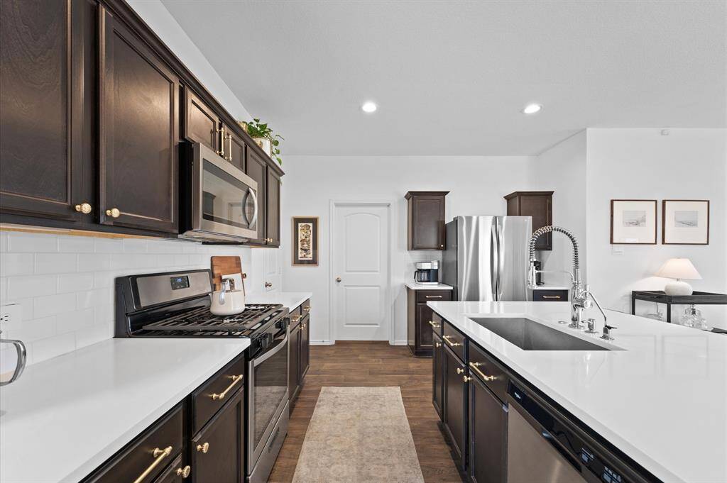 Kitchen upgrades include, quartz countertops, backsplash, water filtration system, large stainless steel sink and faucet.