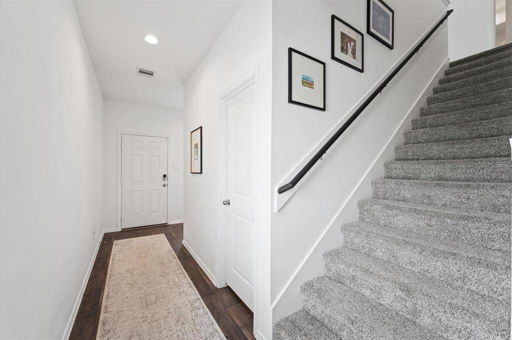 This barely lived in home has a flex/game room located at the top of the stairs.
