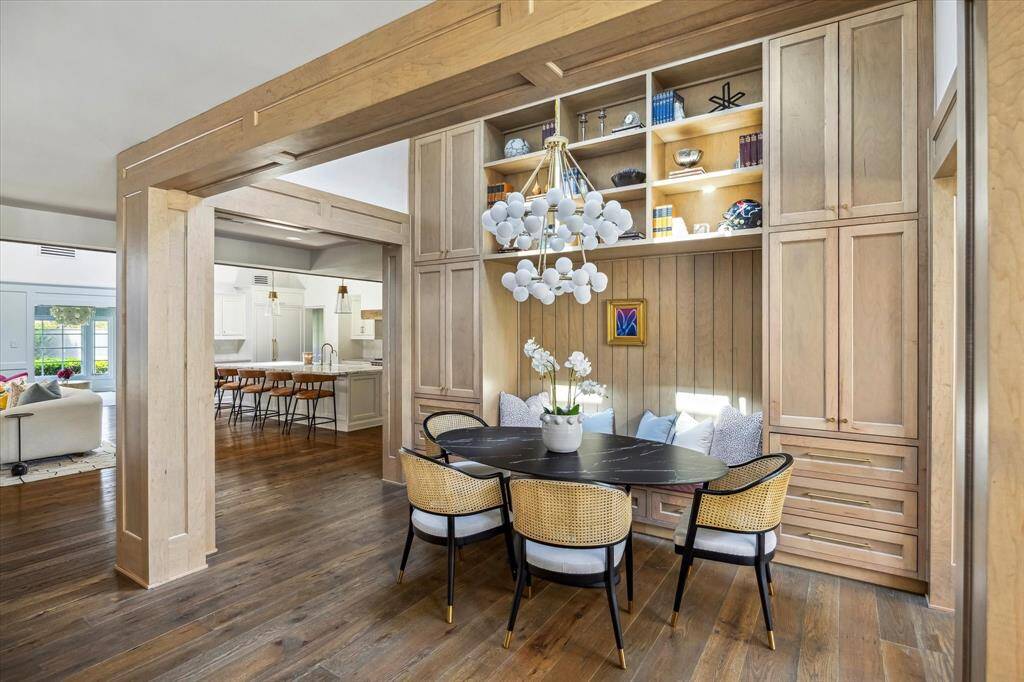 Directly off of the kitchen is the breakfast nook. The breakfast nook features a built-in banquette and numerous cabinets and drawers.