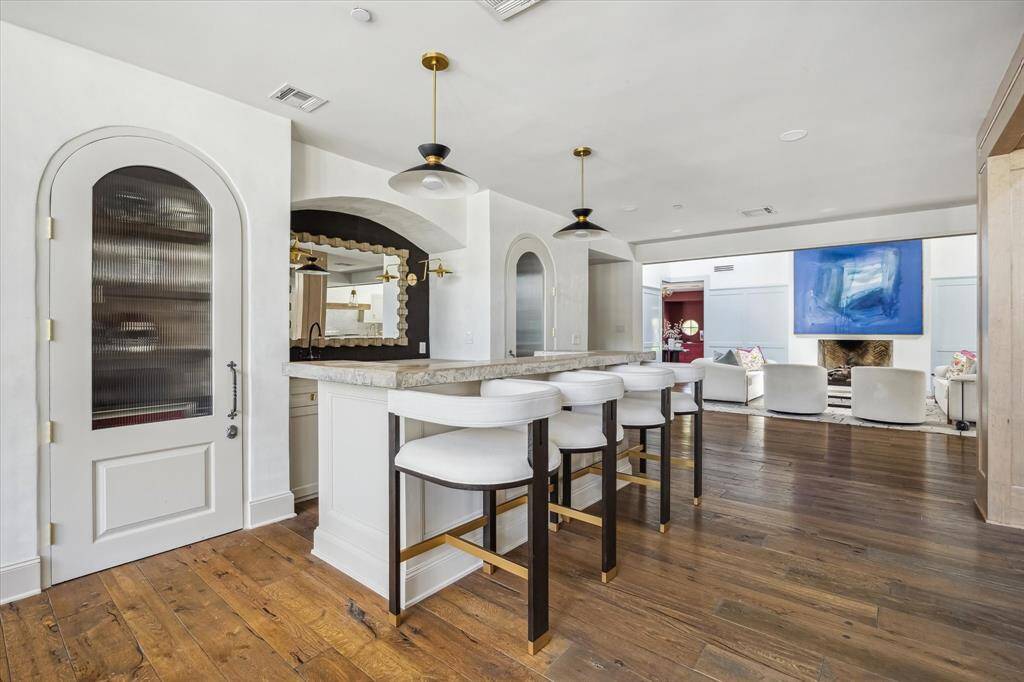 Across from the breakfast nook is the wet-bar, which is equipped with a beverage refrigerator, ice maker, and dual closets for wine storage.