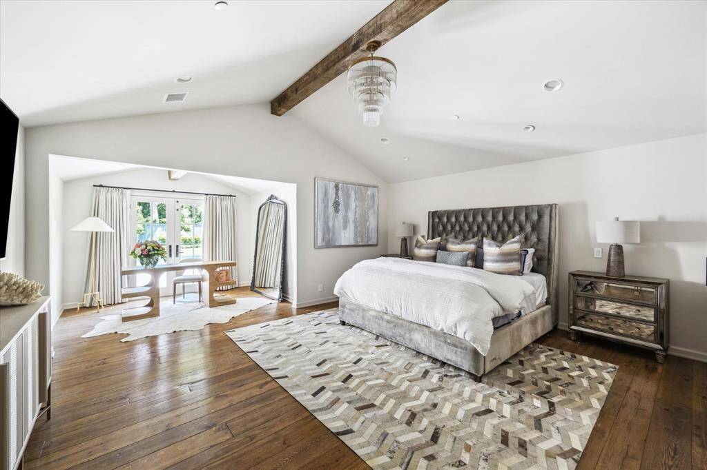 The spacious primary suite includes a sitting area, expansive closet, and a beautifully finished en-suite bath with soaking tub and separate shower.