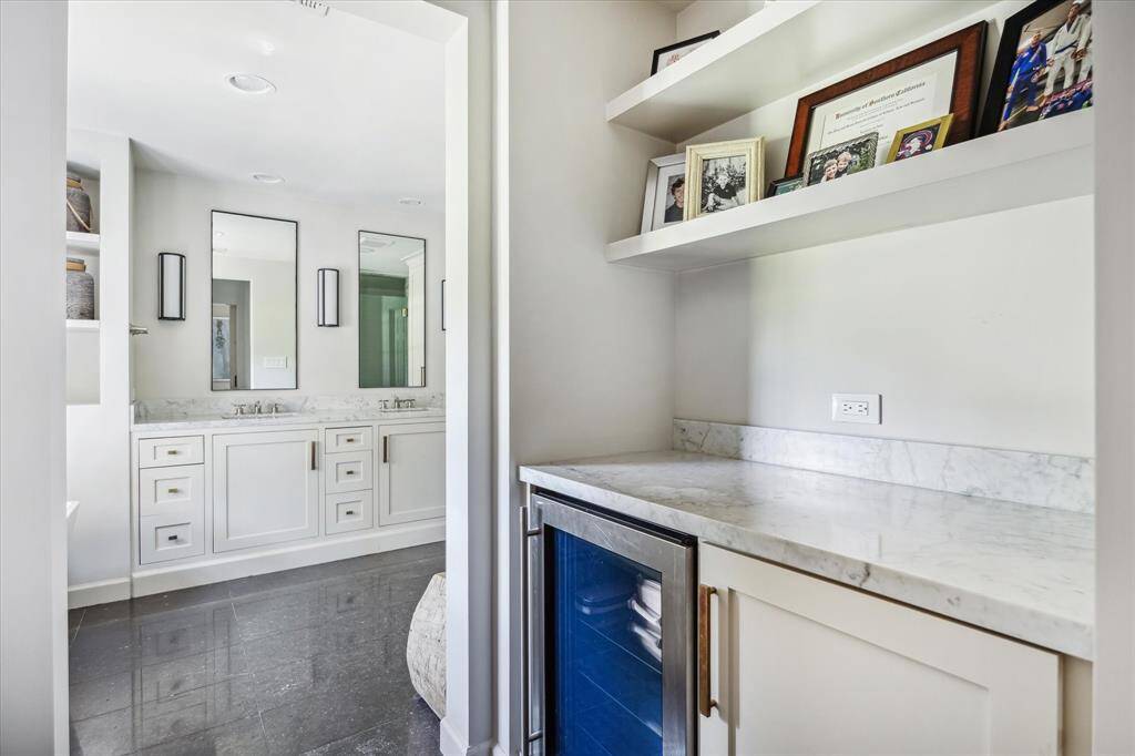 The primary bathroom has a dry bar, coffee station with a beverage refrigerator.