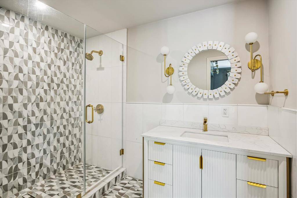 This secondary bathroom features a walk-in shower.