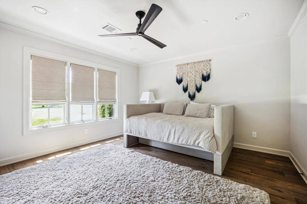 This secondary bedroom features front-facing windows, an en-suite bathroom, and 2 closets.