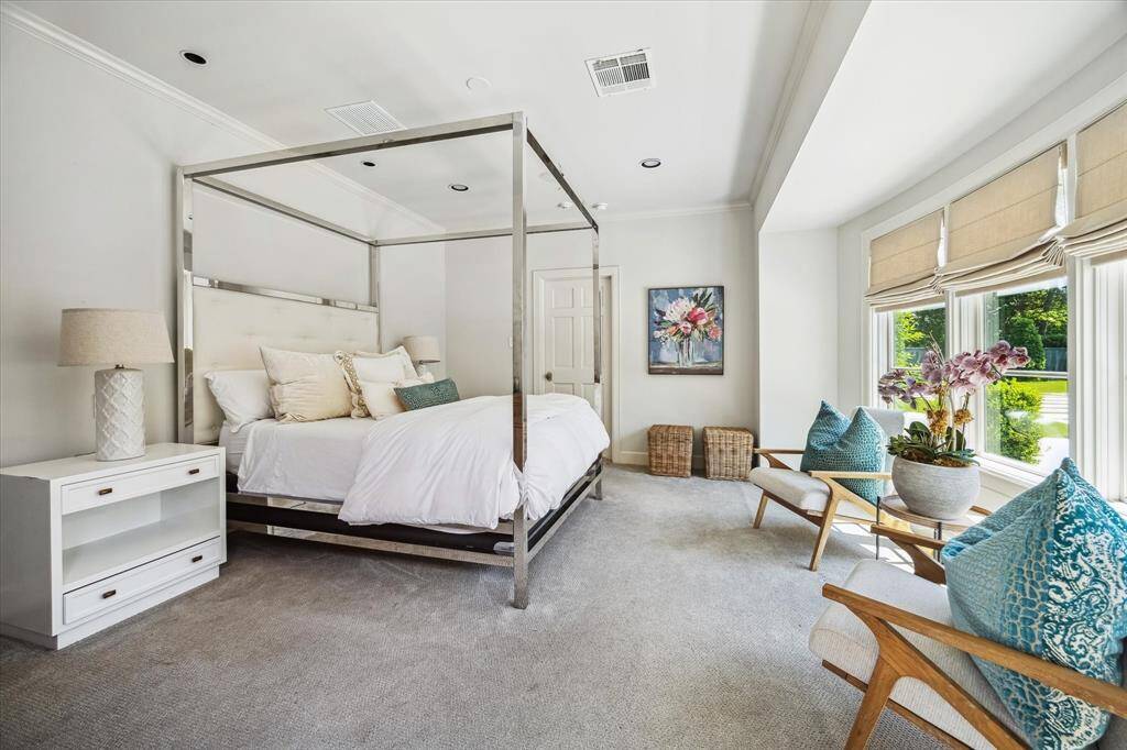 The separate quarters houses a gym, full bath, and guest bedroom with a walk-in closet.