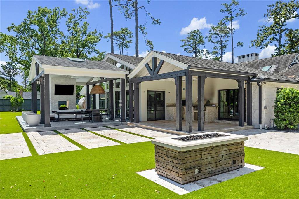 Located off of the outdoor patio is a summer kitchen with a beverage refrigeration and a firepit.