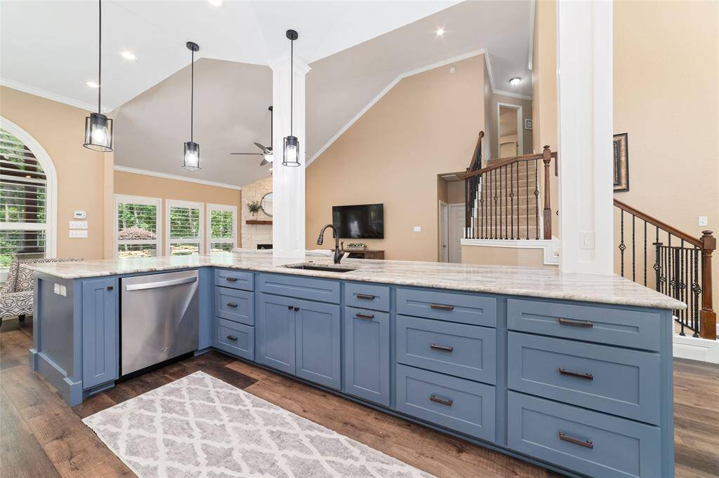 A massive center island offers plenty of prep space, serving area, and seating, perfect for gatherings.