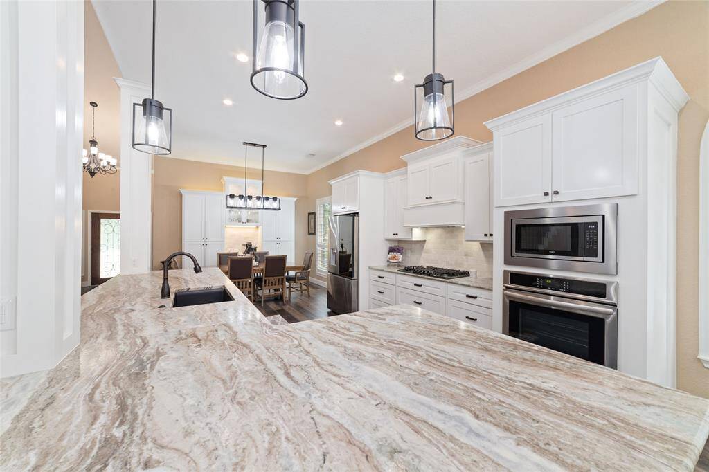 Stunning leather-finish granite countertops add a unique and luxurious touch to the entire kitchen.
