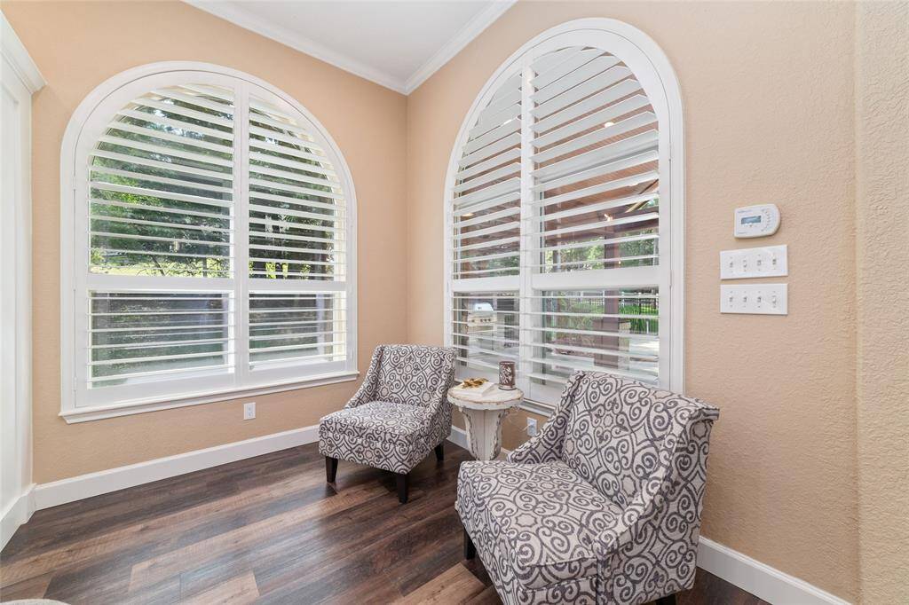 A serene sitting area overlooks the pool, providing a relaxing retreat with a view. Can also be used as the breakfast room.