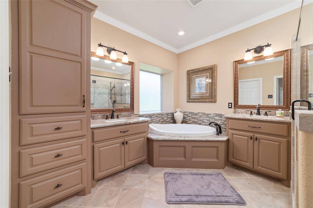 The primary bathroom includes modern finishes and a large vanity area for everyday luxury.