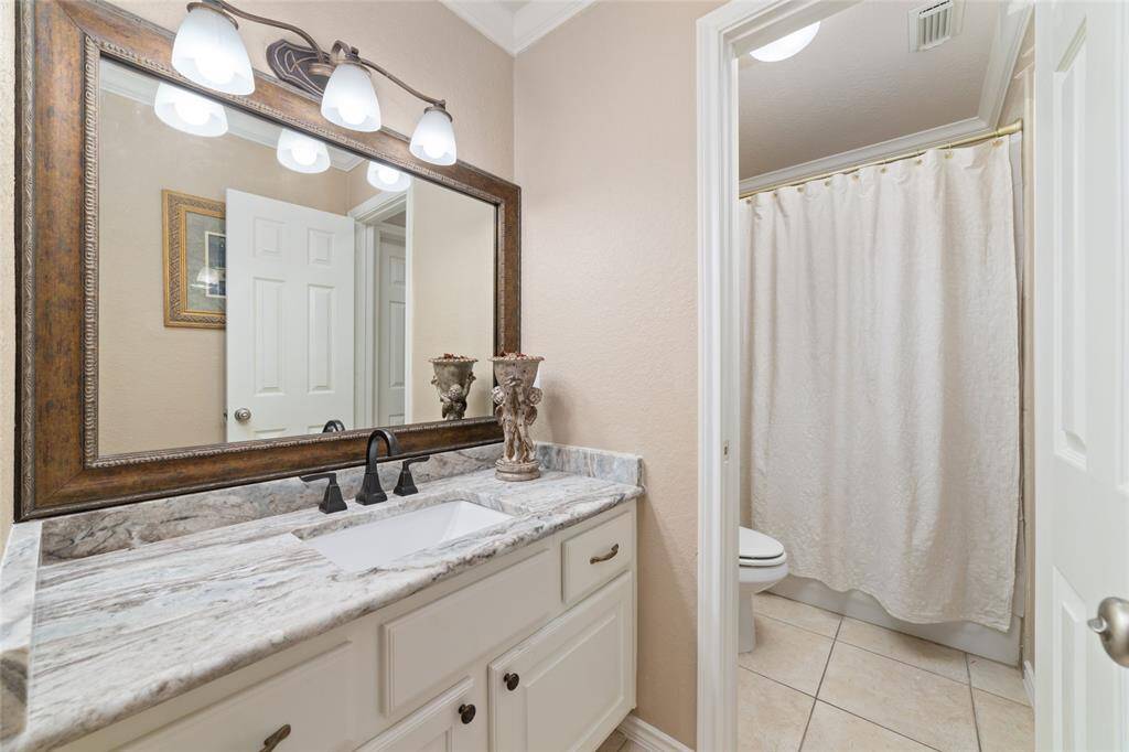 A Jack-and-Jill bathroom connects the upstairs bedrooms, providing functional access and privacy.