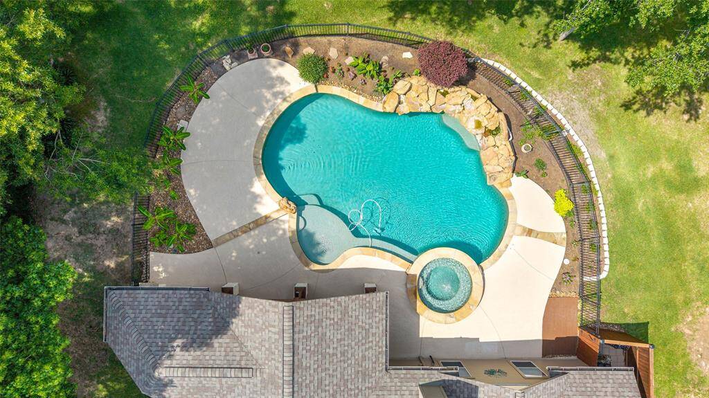 The backyard is a true oasis, anchored by a large resort-style pool perfect for entertaining or relaxing.