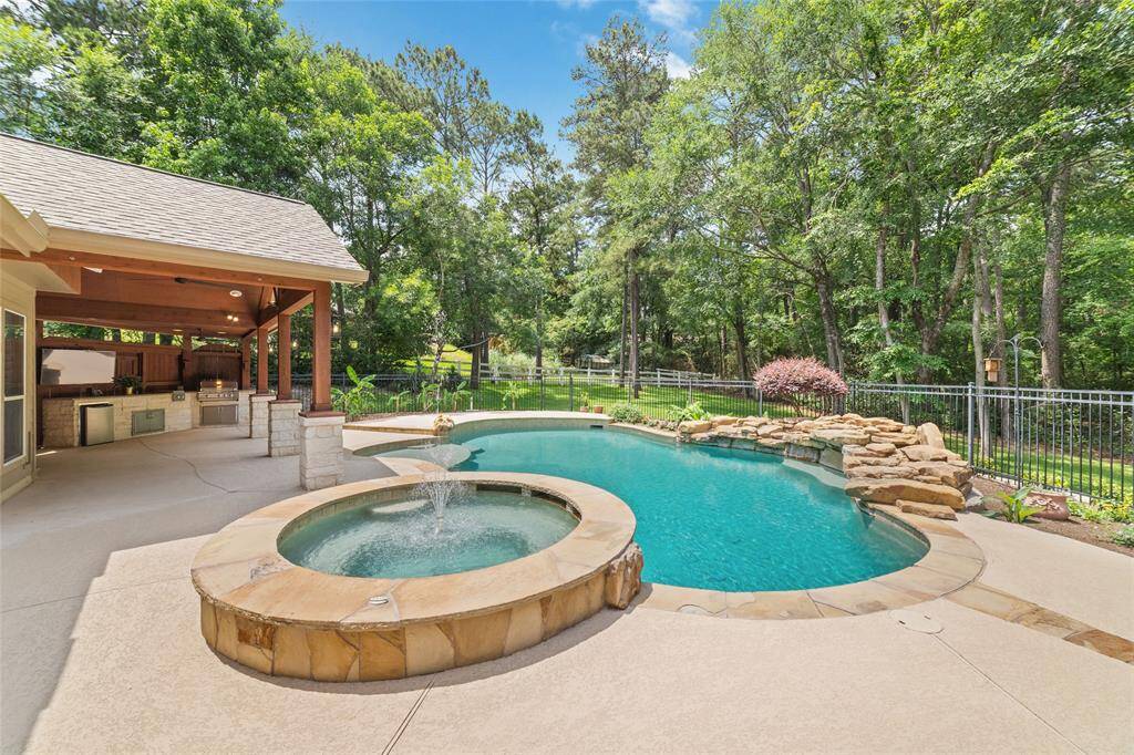 Natural rock formations and cascading waterfalls enhance the luxury feel and visual appeal of the poolscape.