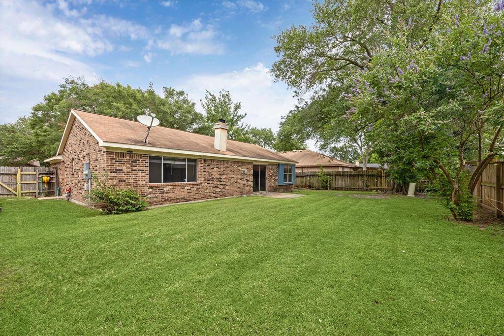 Spacious backyard with a private fenced area offers great outdoor space.