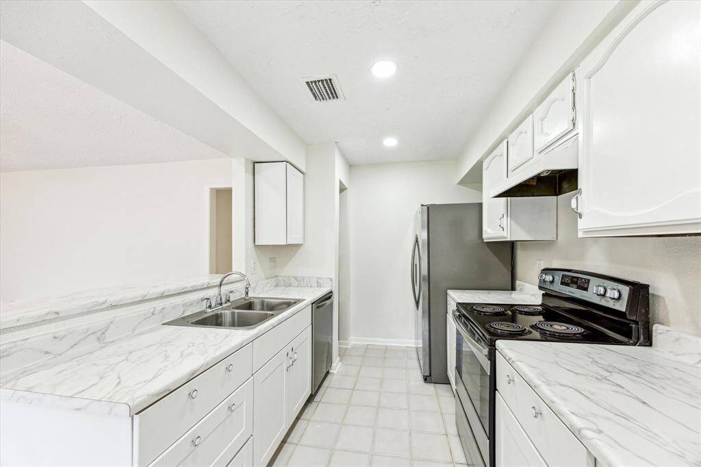 The beautiful kitchen has an abundance of cabinets and counter space.