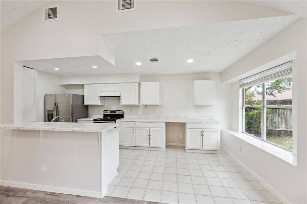 From the living area, looking into the large kitchen and breakfast area.