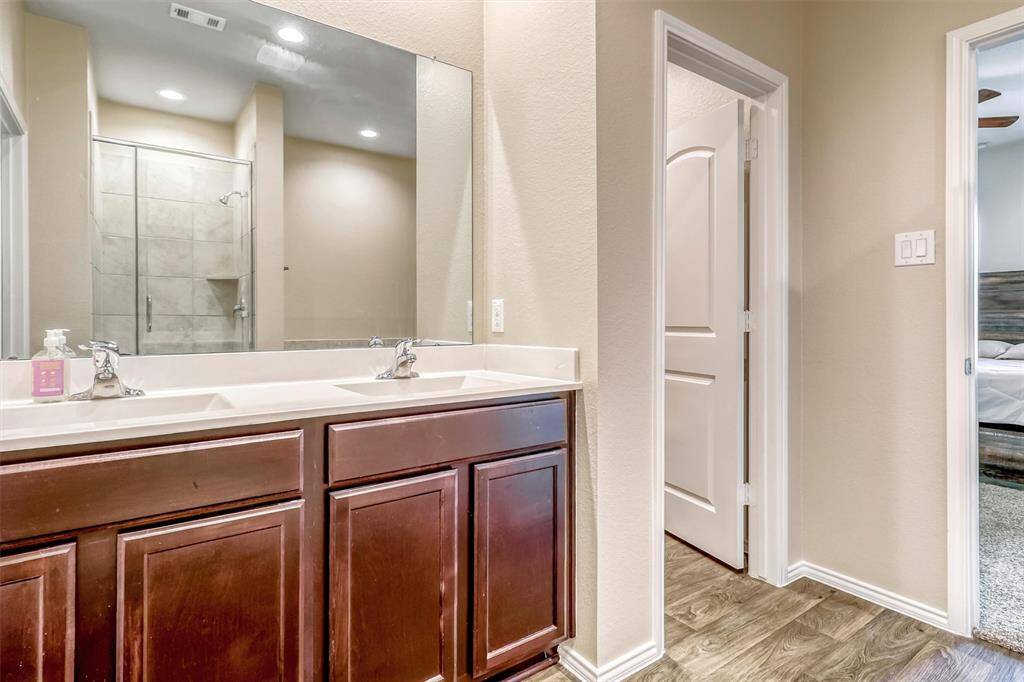 Primary bath is equipped with two sinks for convenience.