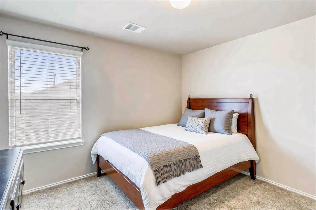 Restful and peaceful secondary bedroom has a large windows for beautiful natural light.