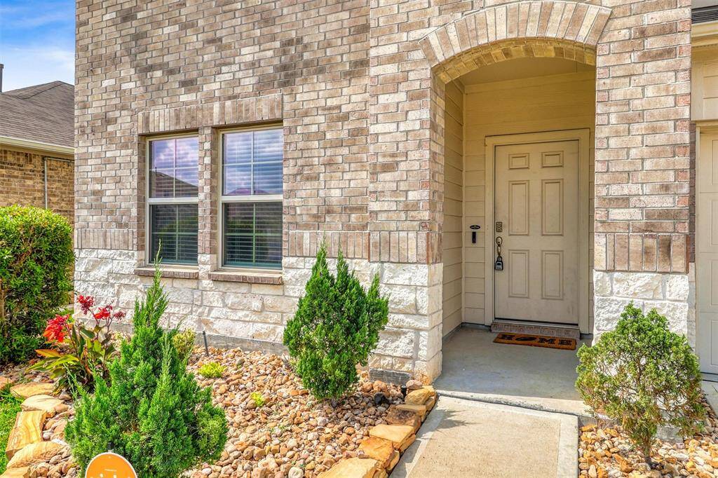 Set behind a graceful arch, the covered entryway provides a perfect pause between the vibrancy of the neighborhood and the calm interior that awaits.