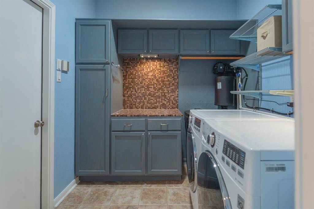 Spacious utility/mudroom located directly off generous three car garage.