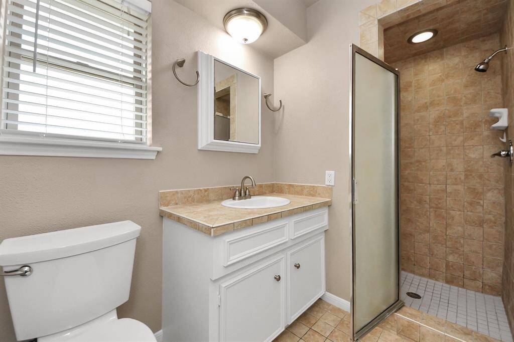 Private ensuite bath featuring a sleek stand-up shower, offering both style and convenience.