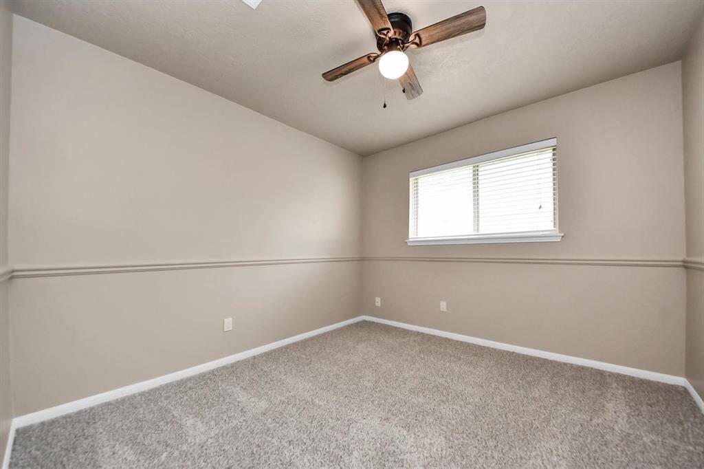 Bedroom #3, perfect for a guest room, home office, or playroom, with plenty of natural light and ample closet space for added convenience.