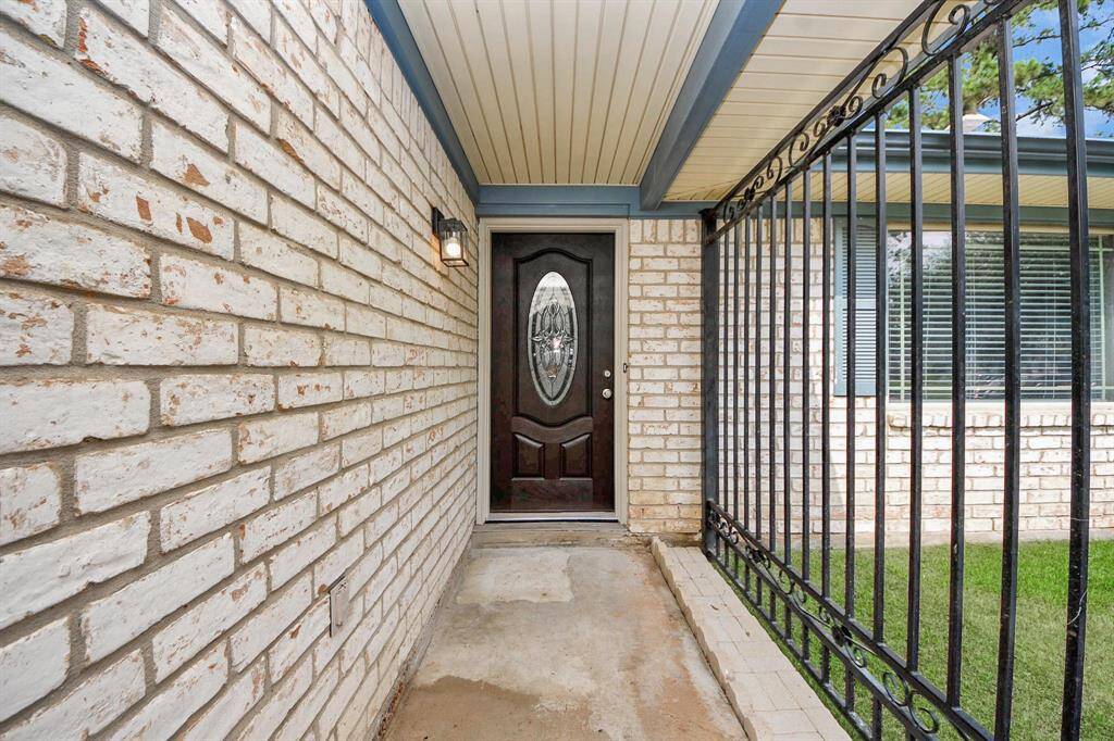 Front door, beautifully accented by an elegant glass insert—blending timeless style with natural light and welcoming warmth