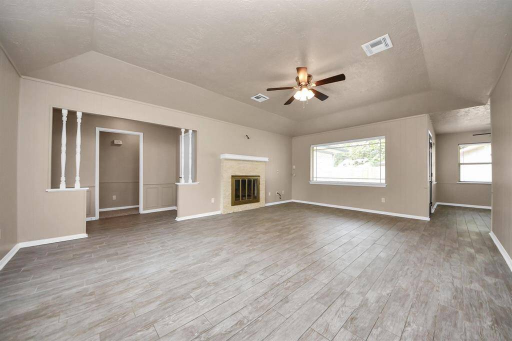 Gorgeous wood-look porcelain tile flooring flows through the main living areas, combining the warmth of wood with the durability and ease of tile.